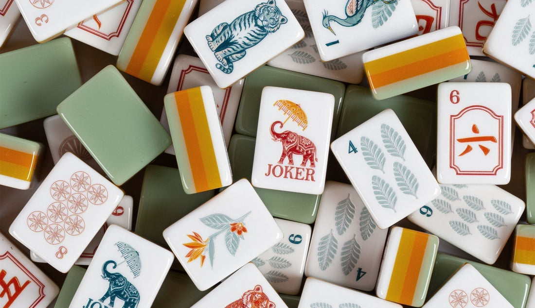 American mahjong tiles scattered across a table showcasing colorful acrylic tile designs