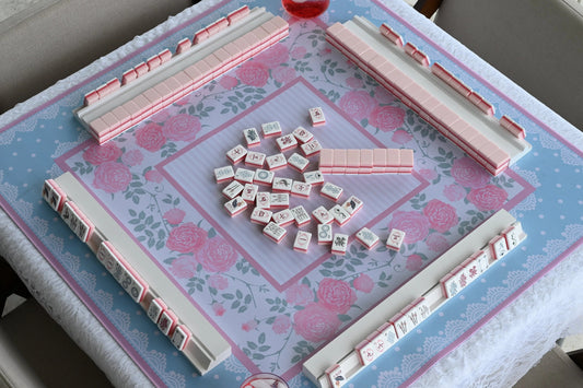 Friends learning how to play American mahjong together at a coordinated Sweet Jojo Mahjong table